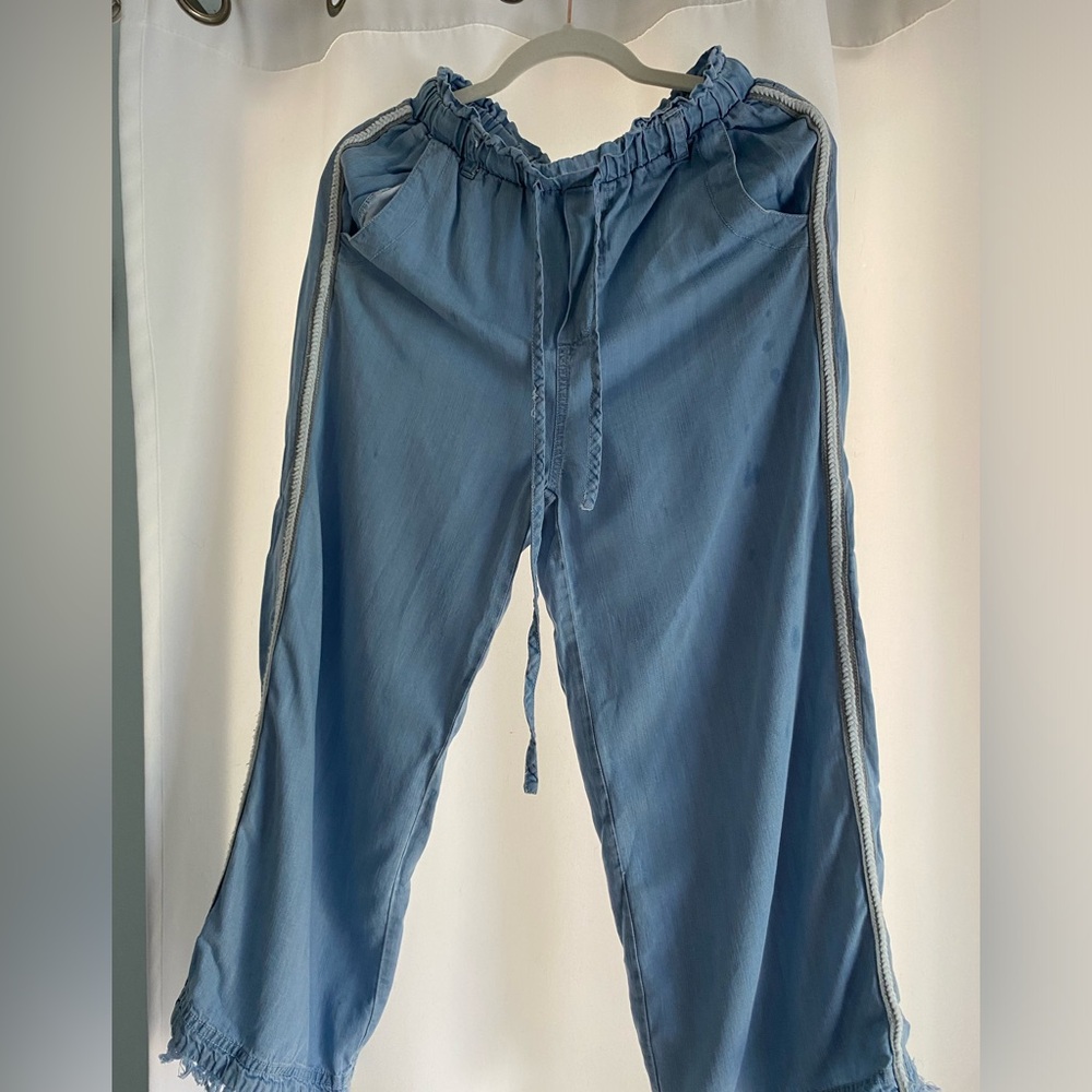 Soft light denim material pants with white embroidery on side seam